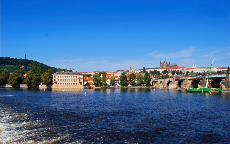 4 - A scenic view across the Vltava River toward the historic Charles Bridge and Prague Castle in Prague, Czech Republic